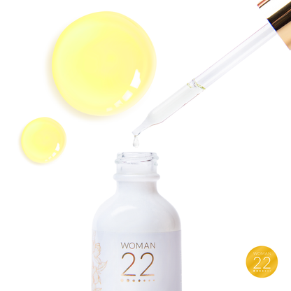 Woman 22 Golden Rainforest Serum dropper application – easy daily use of our golden botanical serum for women's menstrual wellness